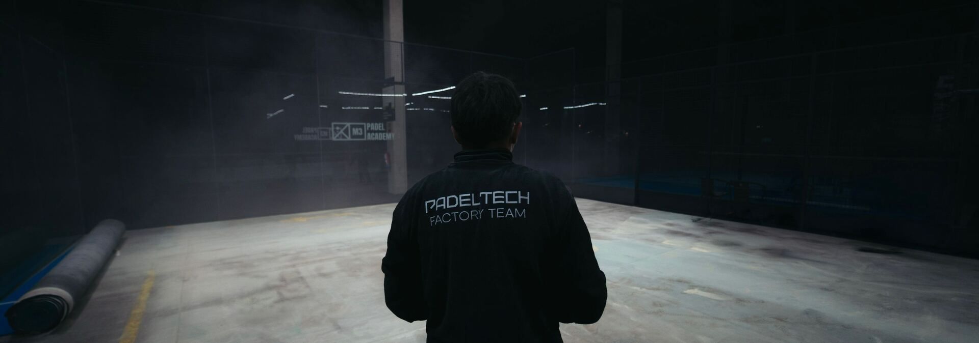 Padel Tech installation specialist overlooking a professional indoor padel court